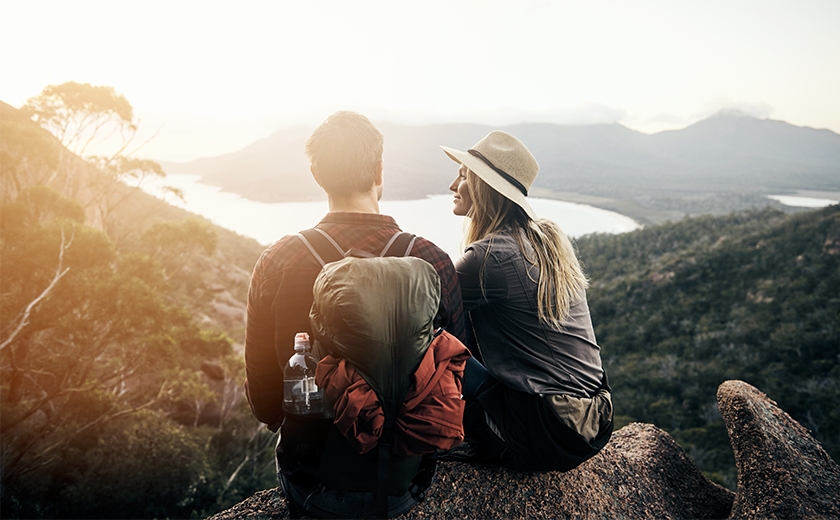 man and woman hiking in the mountains