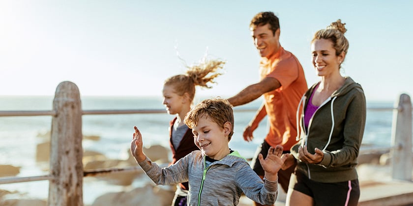 family running past a beach desktop banner