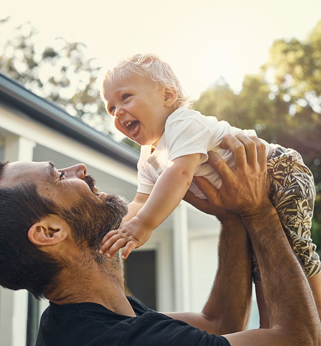 father lifting child above his head